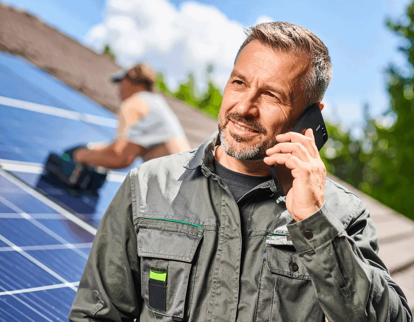 Service technician on the phone while working in the field