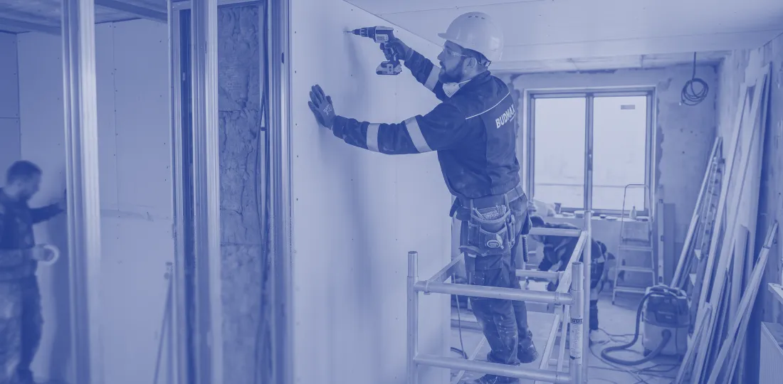 Installer working on drywall gypsum partitions