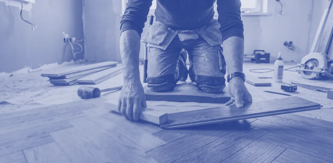 Flooring specialist laying a wooden floor